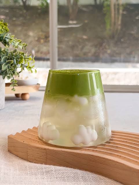 Matcha cloud drink with soft white foam clouds in a mountain-shaped glass